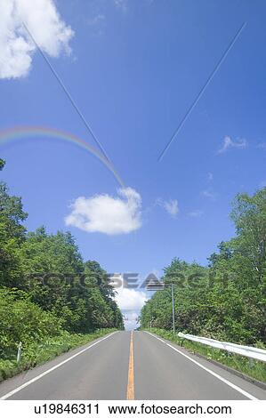 Stock Image - Rainbow over road, Towada, Aomori Prefecture, Japan. Fotosearch