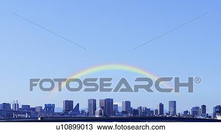 Stock Image - Rainbow over Tokyo skyline, Japan. Fotosearch