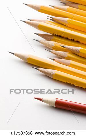 Stock Photo - Red pencil standing out from group of yellow pencils. Fotosearch