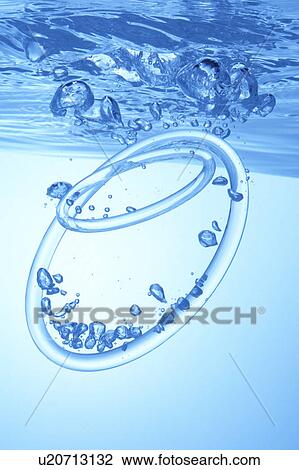 Stock Image - Rings dropped in water, blue background. Fotosearch