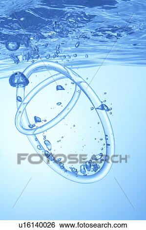Stock Photograph - Rings dropped in water, blue background. Fotosearch