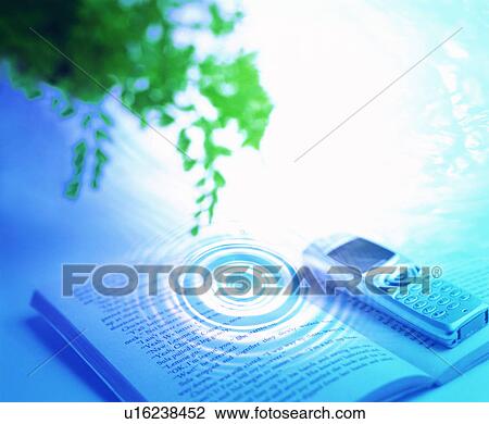 Stock Image - Ripple and tree branch over mobile phone and a book. Fotosearch