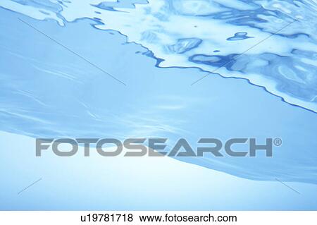 Stock Photo - Rippled water surface, close up, blue background. Fotosearch