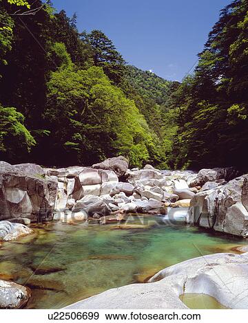 River flowing over rocks, Omogo-kei, Kumakougen-machi, Ehime Prefecture, Japan View Large Photo Image Stock Photo - River flowing over rocks, Omogo-kei, Kumakougen-machi, Ehime Prefecture, Japan. Fotosearch