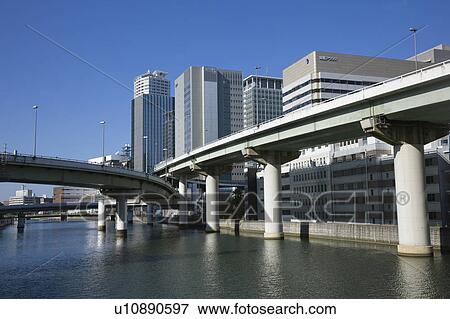 River lined with skyscrapers. Nakanoshima, Nishi-ku, Osaka, Japan View Large Photo Image Stock Photo - River lined with skyscrapers. Nakanoshima, Nishi-ku, Osaka, Japan. Fotosearch