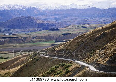 Stock Image - Road through the mountains, New Zealand. Fotosearch