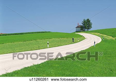 Stock Image - Road winding through fields, Germany, Europe. Fotosearch