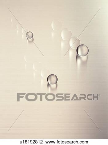 Stock Image - Rolling glass marbles. Fotosearch