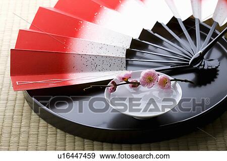 Stock Photo - Sake and a folding fan on a tray. Fotosearch