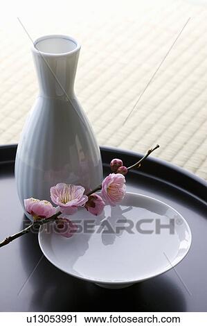 Stock Image - Sake and plum blossoms. Fotosearch