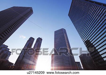 Stock Photo - Shinjuku high-rise complex and the setting sun, Shinjuku-ku, Tokyo, Japan. Fotosearch
