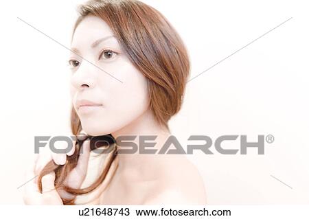 Stock Image - Side View of Young Woman, Holding Her Hair. Fotosearch