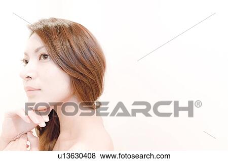 Stock Photo - Side View of Young Woman, Resting Her Chin on Right Hand. Fotosearch