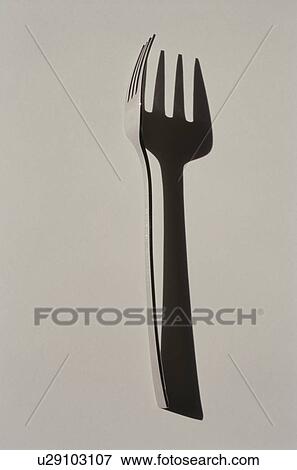 Stock Photo - Silver fork with shadow on white background. Fotosearch