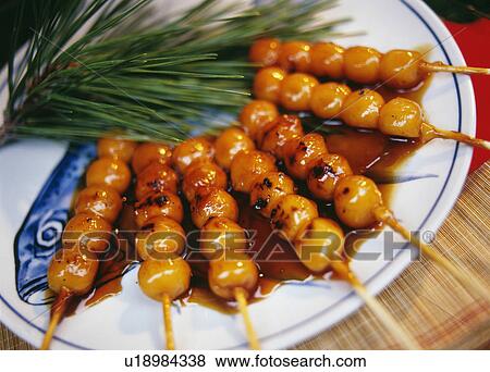 Stock Photo - Skewered dumplings with brown sauce. Fotosearch