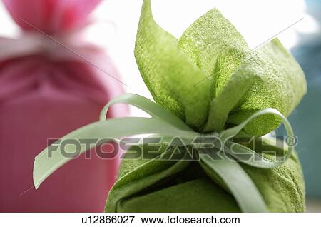 Stock Photo - Small gift boxes wrapped in tissue paper. Fotosearch