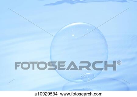 Picture - Soap bubble on water surface, blue background. Fotosearch