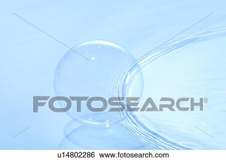 Stock Photograph - Soap bubble on water surface, blue background. Fotosearch