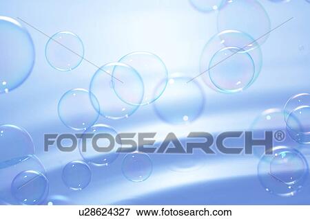 Stock Photo - Soap bubbles over water surface, blue background. Fotosearch