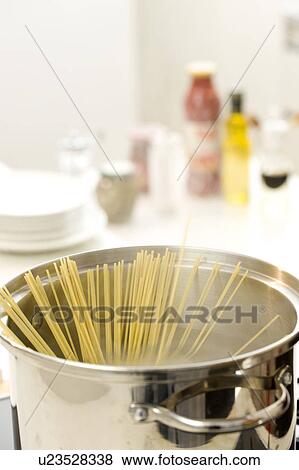 Spaghetti boiling in a pot of water View Large Photo Image Stock Photo - Spaghetti boiling in a pot of water. Fotosearch