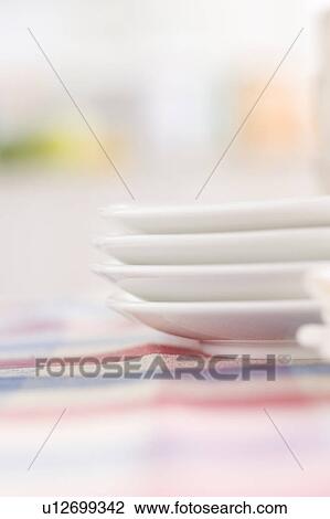 Stock Image - Stack of dishes on a table. Fotosearch
