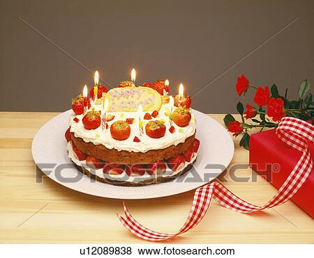 Stock Photo - Strawberry birthday cake on table. Fotosearch