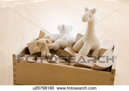 Stock Image - Stuffed animals and building blocks in a box. Fotosearch
