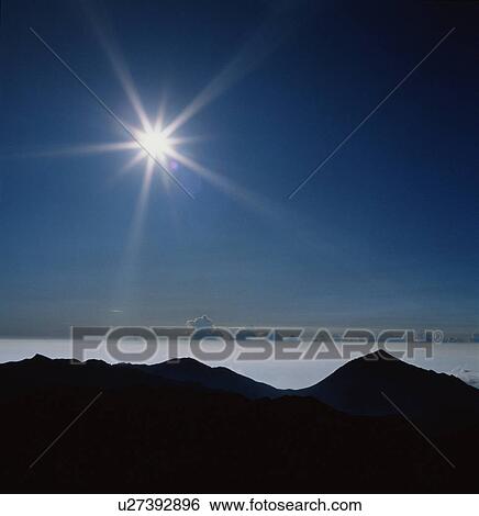 Stock Photograph - Sun over mountains. Fotosearch