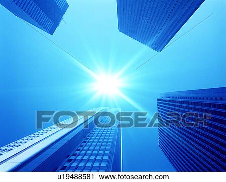 Stock Image - Sun shining over skyscrapers. Fotosearch