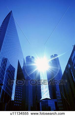 Stock Photography - Sun shining through skyscrapers. Fotosearch