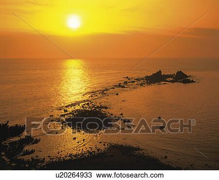 Stock Image - Sunrise over sea, Manazuru-machi, Kanagawa Prefecture, Japan. Fotosearch
