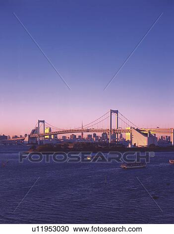 Stock Image - Sunrise over the Rainbow Bridge, Odaiba, Minato-ku, Tokyo, Japan. Fotosearch