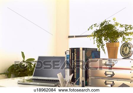Table with drawers, laptop and books View Large Photo Image Picture - Table with drawers, laptop and books. Fotosearch