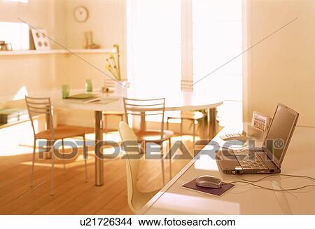 Picture - Table with laptop computer. Fotosearch