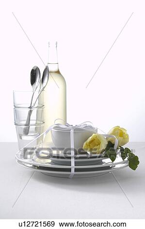 Tableware tied with a white ribbon and white roses View Large Photo Image Stock Photo - Tableware tied with a white ribbon and white roses. Fotosearch