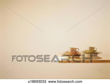 Tea cups and saucers on table View Large Photo Image Stock Image - Tea cups and saucers on table. Fotosearch