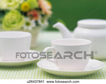 Stock Image - Tea cups and teapot on table. Fotosearch