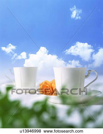 Stock Photo - Tea cups outside with a rose. Fotosearch