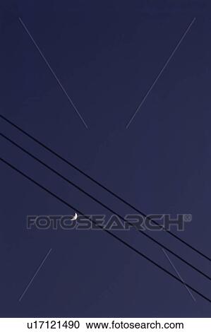 Stock Image - Telephone wire and the moon. Fotosearch