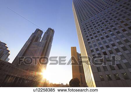 Stock Photography - The Tokyo Metropolitan Government Offices and the setting sun, Shinjuku-ku, Tokyo, Japan. Fotosearch
