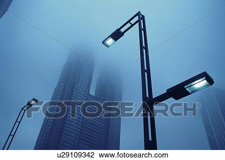 Stock Image - Tokyo Metropolitan Government Building and street lights. Shinjuku, Tokyo, Japan. Fotosearch
