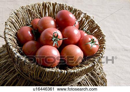 Stock Image - Tomatoes in a bamboo basket. Fotosearch