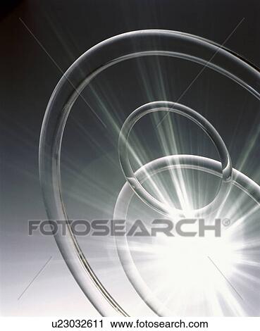 Transparent rings and burst of light on grey background View Large Photo Image Stock Image - Transparent rings and burst of light on grey background. Fotosearch
