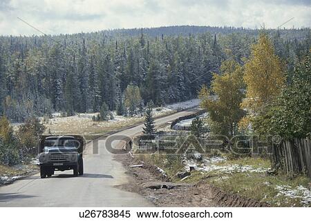 Stock Photography - Truck driving through Taiga, Russia. Fotosearch
