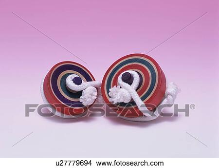 Picture - Two spinning tops. Fotosearch