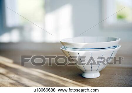 Two teacups stacked on a table View Large Photo Image Stock Photo - Two teacups stacked on a table. Fotosearch
