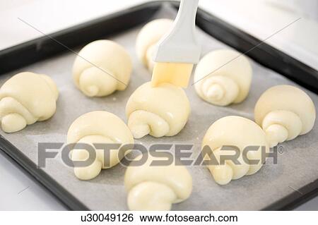 Stock Photograph - Unbaked bread on a tray. Fotosearch