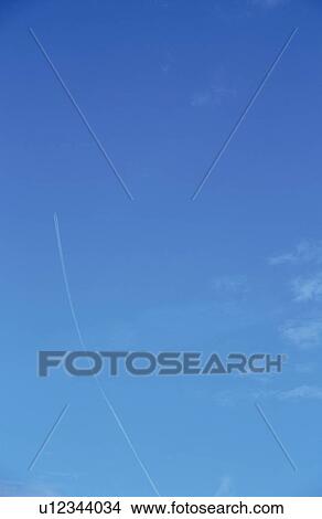 Picture - Vapor trail in blue sky. Fotosearch