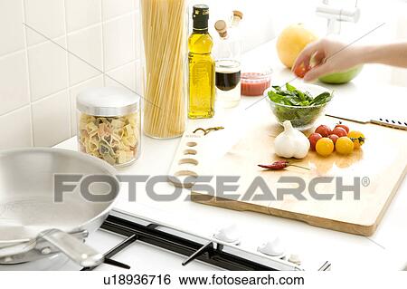 Stock Photograph - Vegetable, spice and herb on cutting board. Fotosearch