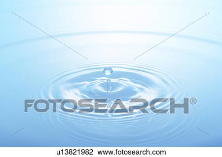 Stock Image - Water drop, close up, blue background. Fotosearch